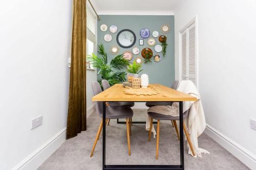 a dining room with a wooden table and chairs at Boho Chic - Stylish Home in City Centre, Sleeps 4 in Darlington