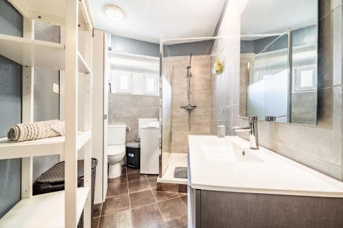 a bathroom with a sink and a toilet at Appartement Proche Lac et Thermes in Thonon-les-Bains