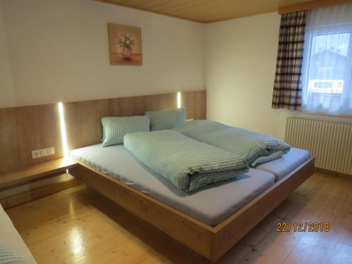 a bed with two pillows on it in a room at Ferienwohnung Birgit in Sankt Gallenkirch