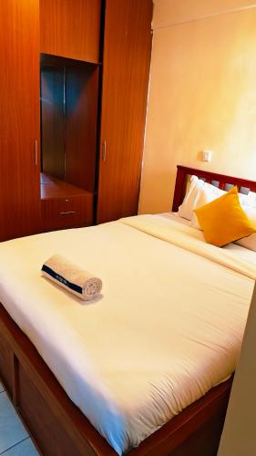 a bed with a book sitting on top of it at Shima Complex in Nakuru