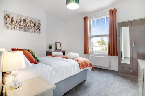 a white bedroom with a bed and a window at 2 Bed Cottage with Garden & Stunning Field Views in Durham