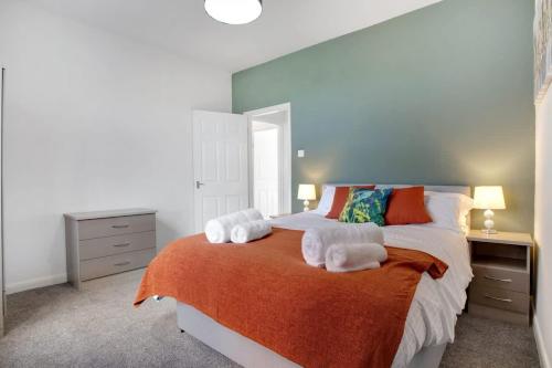 a bedroom with a large bed with towels on it at 2 Bed Cottage with Garden & Stunning Field Views in Durham