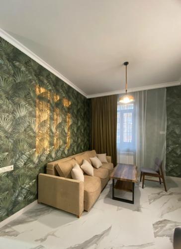 a living room with a couch and a table at S-Van Cozy Home in Sevan