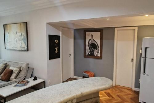 a living room with a couch and a refrigerator at Alphaville Serviced Apartment São Paulo in Barueri