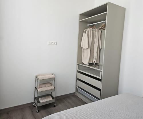 a bedroom with a walk in closet with a bed at Atomium Apartment 1 in Brussels