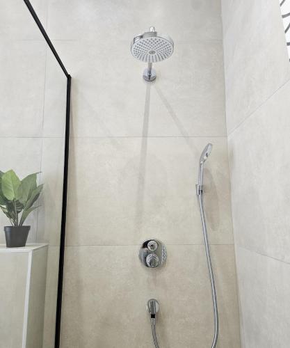 a shower with a shower head in a bathroom at Atomium Apartment 1 in Brussels