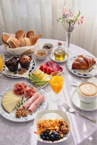 a table with plates of breakfast food on it at Hotel La Noyesa *** Superior in O Grove