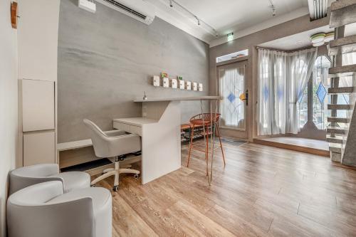 a living room with a desk and chairs and a table at Wuyu in Tainan