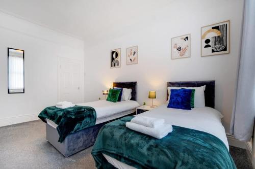 two beds sitting next to each other in a room at Spacious 3-Bed Home in South Shields, Sleeps 8 in South Shields
