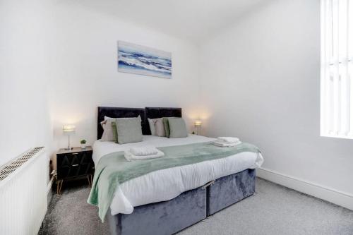 a white bedroom with a large bed and a window at Spacious 3-Bed Home in South Shields, Sleeps 8 in South Shields