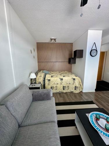 a living room with a couch and a bed at Pohjankaira in Rovaniemi