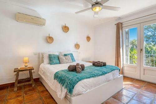 a bedroom with a bed with two teddy bears on it at Robis Moraira in Benissa