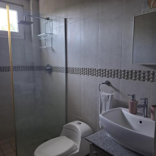 a bathroom with a toilet and a sink and a shower at Rio Mar Villages in San Carlos