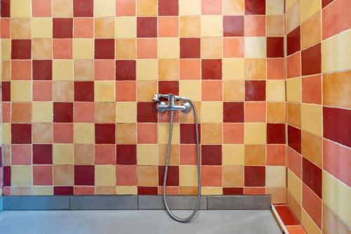 a shower in a bathroom with a tiled wall at Maison de charme a Bayonne in Bayonne
