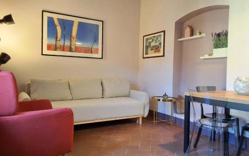 a living room with a couch and a table at Sky Loft La Melissa - Pisa Center in Pisa