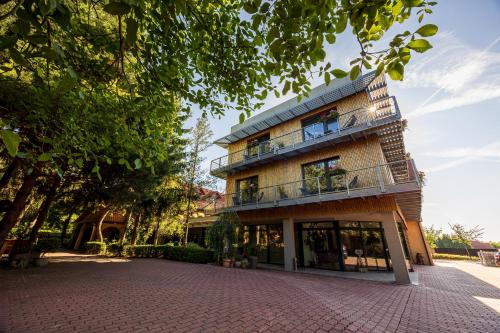 a building with a brick driveway in front of it at Hotel Frýdl in Prague