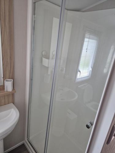 a shower with a glass door in a bathroom at Sharmar Eyemouth in Eyemouth