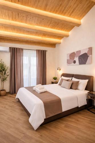 a large bed in a bedroom with a wooden ceiling at Sicily Luxury Rooms in Palermo