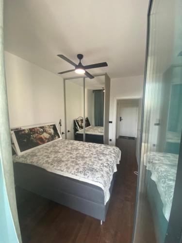 a bedroom with two beds and a ceiling fan at Unin Apartman, Kosmaj Renew, Rogača in Rogača