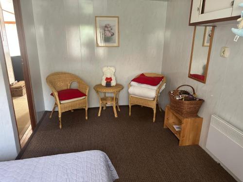 a bedroom with a bed and a table and chairs at Lilia Chalet in Durbuy