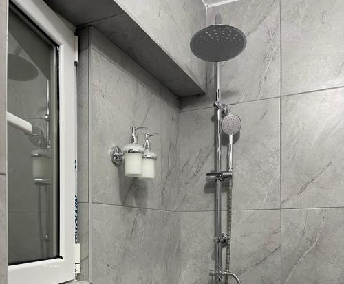 a shower in a bathroom with a shower head at Helios in Ioannina