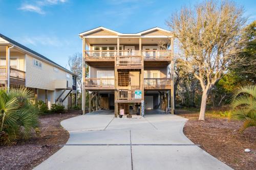 a large apartment building with a walkway at Beach 45 by Oak Island Accommodations in Oak Island