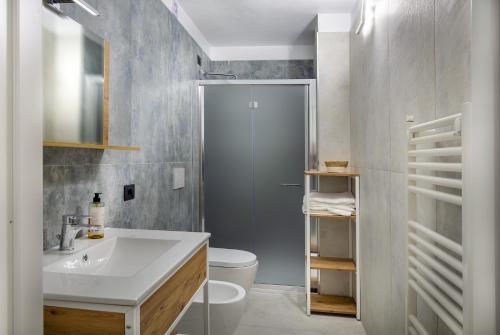 a bathroom with a sink and a toilet and a shower at Hotel Darsena in Passignano sul Trasimeno
