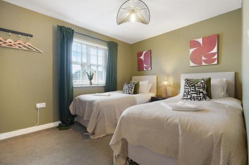 a bedroom with two beds and a window at Stylish Teesside Home Ideal for Work or Leisure in Stockton-on-Tees