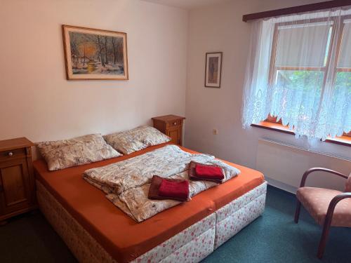a bedroom with a bed with two pillows on it at Rodinný Penzion U Nouzů in Staré Hradiště