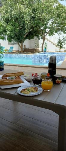 a table with food and drinks on top of it at Villa Nostra in Ngaparou