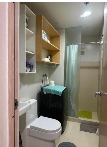 a bathroom with a toilet and a shower at UrbanGem Iloilo in Iloilo City