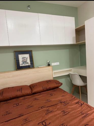 a bedroom with a bed and white cabinets at UrbanGem Iloilo in Iloilo City