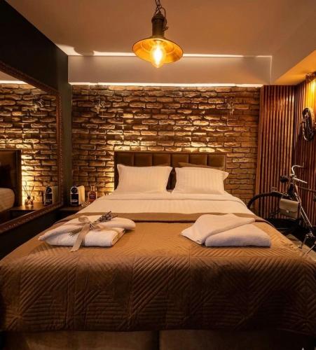 a bedroom with a large bed with towels on it at Vintage Cozy Suite in Vodno