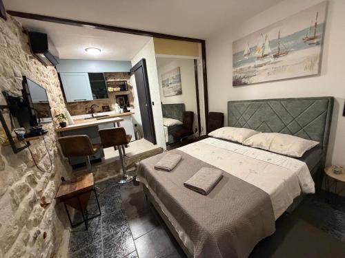 a bedroom with a bed and a desk in it at Dragazzo studio in Trogir