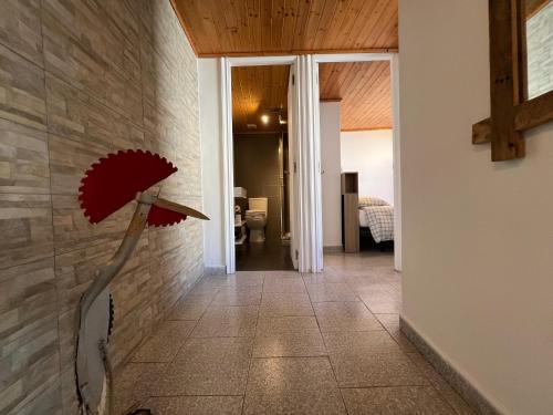 a hallway with a red flower on the wall at Casa La Finca in Vigo