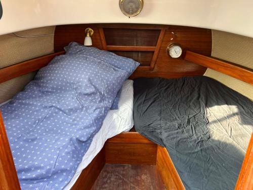 a bed and a pillow in the back of a boat at Romantisk båd nær Kbh in Copenhagen