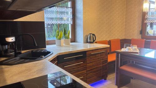 a kitchen with a sink and a counter top at Asenata Apartament 46m2 Ustroń Centrum in Ustroń