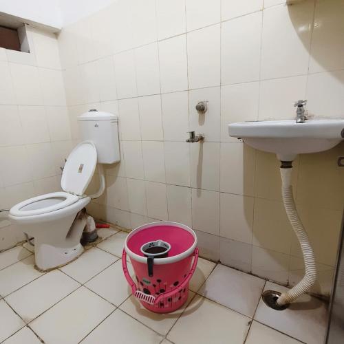 a bathroom with a toilet and a sink at Hotel B B Pride in Raipur