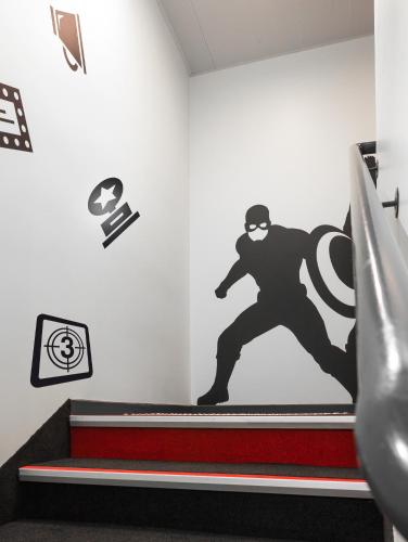 a wall with a superhero mural on the wall at Hôtel Kyriad Rennes Centre Gare in Rennes