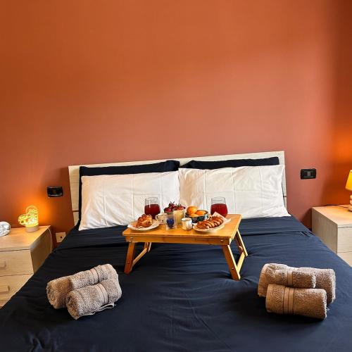 a bed with a tray of food and drinks on it at Panoramic Terrace & Sea View Flat with Free Parking in Genoa