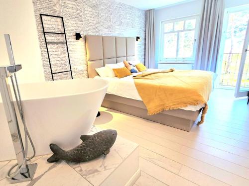 a bedroom with a bed and a fish on the floor at Ferienwohnung Lieblingssuite am Strand in Ahlbeck