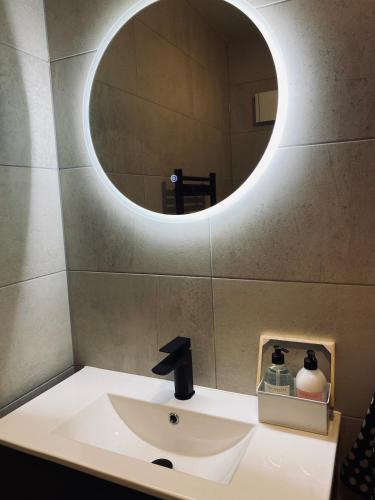 a bathroom with a sink and a mirror at Guest house in Compton in Winchester