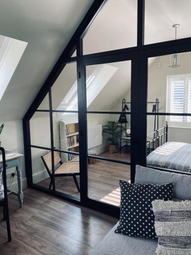 a room with a large glass window and a bed at Guest house in Compton in Winchester