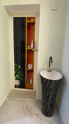 a bathroom with a sink and a window at Bay Breeze Vijay Villa in Pondicherry