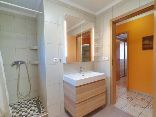 a bathroom with a sink and a mirror at Apartment Anikó Nr 7 in Vonyarcvashegy