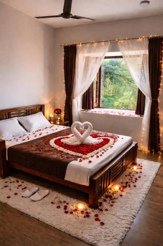 a bedroom with a bed with a heart on it at Bay Breeze Vijay Villa in Pondicherry