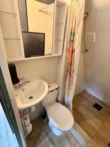 a small bathroom with a toilet and a sink at Domek Kitara in Skorochow