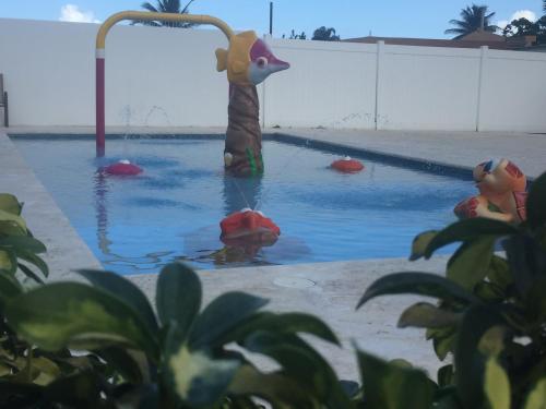a pool with a toy giraffe in the water at Arecibo Inn in Arecibo
