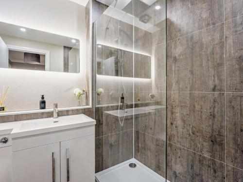 a bathroom with a glass shower and a sink at 1 Bed in Oban oc-96079 in Oban