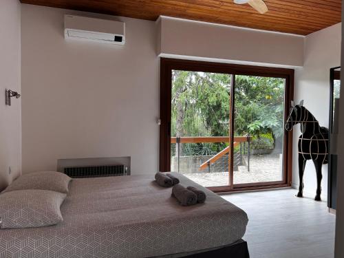 a bedroom with a bed with a giraffe statue in the background at L'Olivada, villa d'exception in Ganges